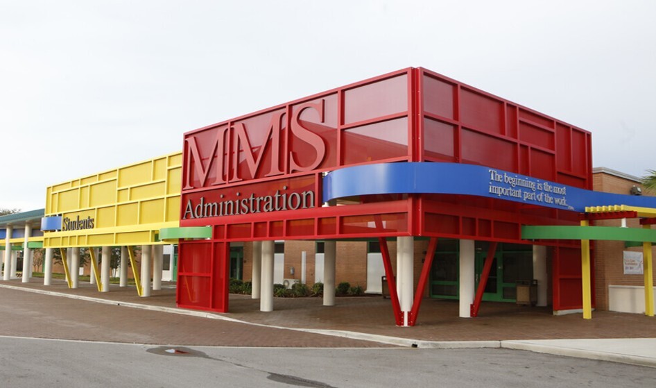 Modern school building with red, yellow, blue and green architectural metal panels